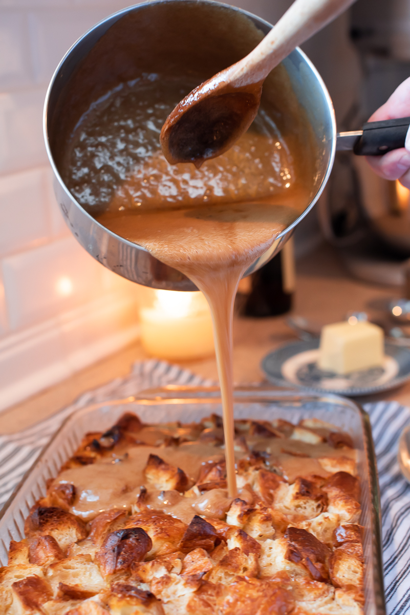 Pouring caramel over Croissant Bread Pudding