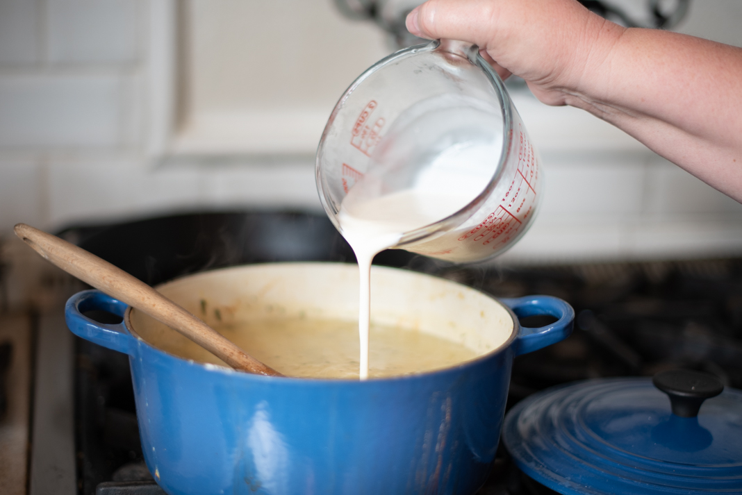 Adding cream to Cream of Potato and Rosemary Soup