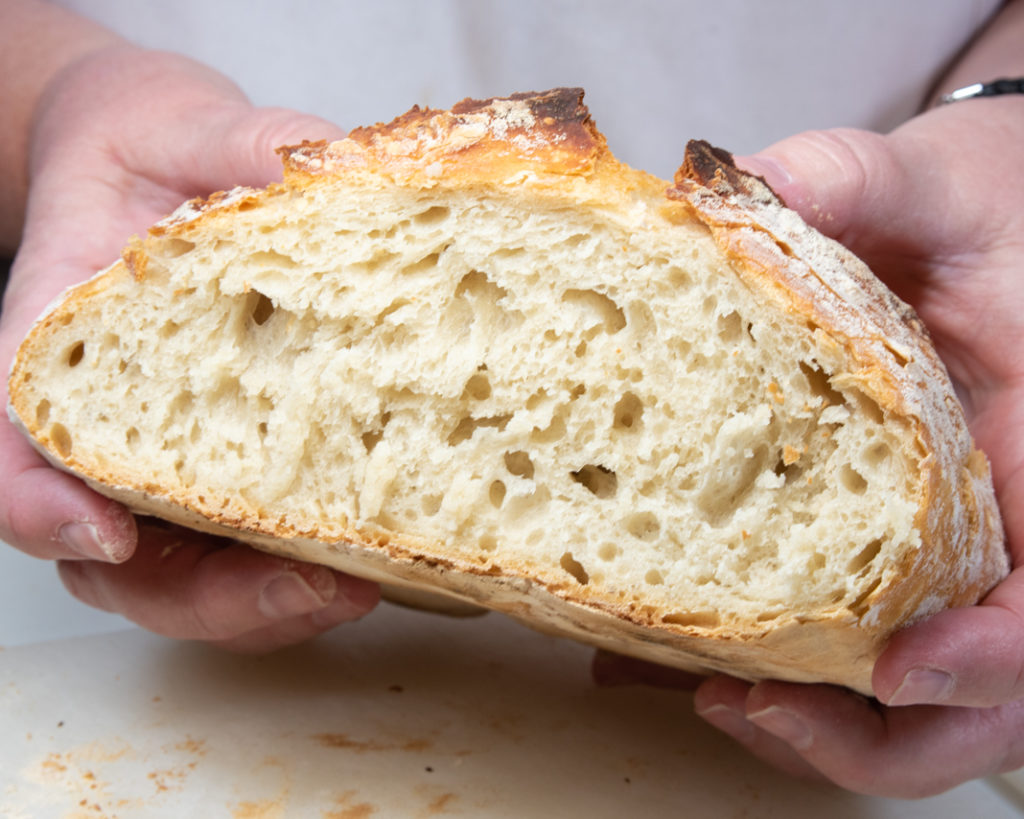 https://omadarling.com/wp-content/uploads/2019/12/Presenting-a-loaf-of-cut-Dutch-Oven-No-Knead-Bread-1-1024x819.jpg